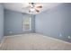 Cozy bedroom with neutral carpet, ceiling fan, and a bright window creating a comfortable atmosphere at 456 Crestmont Ln, Canton, GA 30114