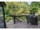 The wooden deck with a black railing features a grill at 456 Crestmont Ln, Canton, GA 30114