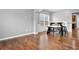 Bright dining room with hardwood floors, a modern table, and wainscoting detail at 456 Crestmont Ln, Canton, GA 30114