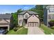Inviting two-story home with well-kept lawn and a two-car garage nestled among mature trees at 456 Crestmont Ln, Canton, GA 30114
