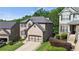 A suburban home with a two-car garage, green lawn, and manicured landscaping, showcasing classic curb appeal at 456 Crestmont Ln, Canton, GA 30114