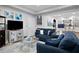 Comfortable living area with blue sofas, a glass coffee table, and a wet bar featuring barstool seating at 456 Crestmont Ln, Canton, GA 30114
