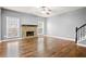 Bright living room boasting hardwood floors, a stone fireplace, and ample natural light from the large windows at 456 Crestmont Ln, Canton, GA 30114