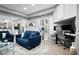 Inviting living area with blue sofas, a dedicated workspace, and stylish decor throughout the open-concept design at 456 Crestmont Ln, Canton, GA 30114
