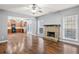 Bright living room flows into a kitchen featuring a fireplace and views to the home's exterior at 456 Crestmont Ln, Canton, GA 30114