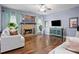 Cozy living room with a stone fireplace, hardwood floors, and ample natural light, creating a warm and inviting atmosphere at 456 Crestmont Ln, Canton, GA 30114