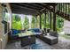 A patio featuring comfortable wicker furniture around a glass-topped gas fire pit at 456 Crestmont Ln, Canton, GA 30114