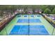 Aerial view of community tennis courts, perfect for active residents and social gatherings, with lush green landscaping at 456 Crestmont Ln, Canton, GA 30114