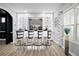 Chic wet bar area with barstool seating, illuminated display shelving, and stylish decorative elements at 456 Crestmont Ln, Canton, GA 30114