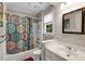Bright bathroom with tub and shower featuring a colorful shower curtain at 710 Devon Hill Ct, Roswell, GA 30075
