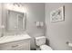 Charming half bathroom featuring marble countertop and decorative artwork at 710 Devon Hill Ct, Roswell, GA 30075