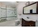 Cozy bathroom featuring a glass shower, framed mirror, and ceramic tile at 710 Devon Hill Ct, Roswell, GA 30075