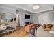 Spacious bedroom featuring tray ceiling, sitting area, and hardwood flooring at 710 Devon Hill Ct, Roswell, GA 30075