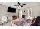Bedroom with tv and view of bathroom with colorful shower curtain at 710 Devon Hill Ct, Roswell, GA 30075