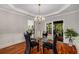 Elegant dining room featuring a glass table, decorative chandelier, and natural light at 710 Devon Hill Ct, Roswell, GA 30075