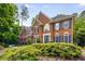 Charming brick home with blue shutters and a manicured front yard, providing a welcoming curb appeal at 710 Devon Hill Ct, Roswell, GA 30075