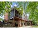 Back of home with two levels of decks, a screened-in porch and stone patio at 710 Devon Hill Ct, Roswell, GA 30075