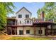 Back of home with two levels of decks, a screened-in porch and stone patio at 710 Devon Hill Ct, Roswell, GA 30075