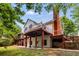 Back of home with two levels of decks, a screened-in porch and stone patio at 710 Devon Hill Ct, Roswell, GA 30075