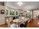 Bright kitchen with large windows, stainless steel appliances, granite countertops, and hardwood floors at 710 Devon Hill Ct, Roswell, GA 30075