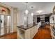 Kitchen island with stainless steel refrigerator and open concept living space at 710 Devon Hill Ct, Roswell, GA 30075