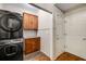 Laundry room with stackable washer and dryer, wood cabinets, and tiled floors at 710 Devon Hill Ct, Roswell, GA 30075