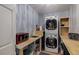 Utility room with stacked washer and dryer and sink at 710 Devon Hill Ct, Roswell, GA 30075