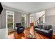 Bright living room with hardwood floors, two armchairs, a stylish glass coffee table, and great natural light at 710 Devon Hill Ct, Roswell, GA 30075