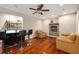Spacious living room featuring hardwood floors, fireplace, bar, ceiling fan and comfortable seating at 710 Devon Hill Ct, Roswell, GA 30075