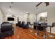 Spacious living room featuring hardwood floors, bar, fireplace, ceiling fan and comfortable seating at 710 Devon Hill Ct, Roswell, GA 30075