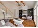 Cozy living room with fireplace, hardwood floors, and large windows offering plenty of natural light at 710 Devon Hill Ct, Roswell, GA 30075