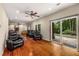 Spacious living room featuring hardwood floors, recessed lighting, ceiling fan, and slider to the outdoors at 710 Devon Hill Ct, Roswell, GA 30075