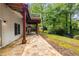 Stone patio with wooded views and exterior stairs at 710 Devon Hill Ct, Roswell, GA 30075