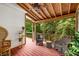 Covered porch with wicker seating and wooded views at 710 Devon Hill Ct, Roswell, GA 30075