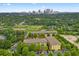 An aerial view showcasing the apartment complex surrounded by lush greenery and the city skyline in the background at 1195 Milton Se Ter # 1407, Atlanta, GA 30315