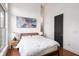Bedroom features a large window, wood floors, a queen bed, and nightstands with lamps at 1195 Milton Se Ter # 1407, Atlanta, GA 30315