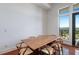 Bright dining room with wood floors, a large wood table, and a view to the outside at 1195 Milton Se Ter # 1407, Atlanta, GA 30315