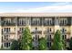 Apartment building featuring multiple units with balconies and lush green trees in front at 1195 Milton Se Ter # 1407, Atlanta, GA 30315