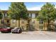 Apartment complex with parking, stairs to units, and mature shade trees on a sunny day at 1195 Milton Se Ter # 1407, Atlanta, GA 30315