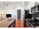 Modern kitchen with stainless steel appliances, an island with bar seating, and open floor plan at 1195 Milton Se Ter # 1407, Atlanta, GA 30315