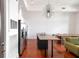 Modern kitchen with stainless steel appliances, an island with bar seating, and hardwood floors at 1195 Milton Se Ter # 1407, Atlanta, GA 30315