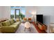 Bright living room boasts hardwood floors, modern furniture, and natural light from large windows with a view at 1195 Milton Se Ter # 1407, Atlanta, GA 30315