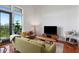 Bright living room boasts hardwood floors, modern furniture, and natural light from large windows with a city view at 1195 Milton Se Ter # 1407, Atlanta, GA 30315