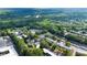 Aerial view of neighborhood and wooded area with winding river and apartment buildings at 305 Winding River Village Dr # F, Atlanta, GA 30350