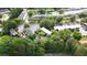 Aerial shot of neighborhood featuring lush greenery, parking lots, and multi-unit buildings at 305 Winding River Village Dr # F, Atlanta, GA 30350