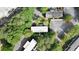 Aerial view of property shows multiple buildings and large parking areas with surrounding mature trees at 305 Winding River Village Dr # F, Atlanta, GA 30350