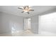 Bedroom features a ceiling fan, a closet, and door to the hallway at 305 Winding River Village Dr # F, Atlanta, GA 30350
