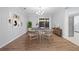 Dining area with decorative wall art, wood floors and a sliding glass door to the backyard at 305 Winding River Village Dr # F, Atlanta, GA 30350