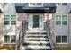 Inviting entrance with brick facade and stairs leading to front door and awning at 305 Winding River Village Dr # F, Atlanta, GA 30350