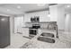 Bright kitchen featuring stainless steel appliances, granite countertops, and white cabinetry at 305 Winding River Village Dr # F, Atlanta, GA 30350
